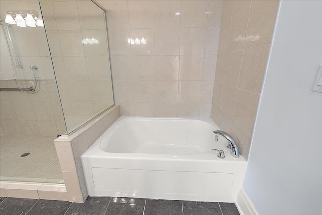 bathroom featuring tile patterned flooring and separate shower and tub