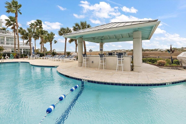 view of pool with a gazebo, exterior bar, and a patio