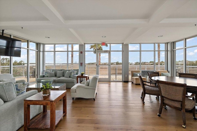 sunroom featuring a healthy amount of sunlight and coffered ceiling