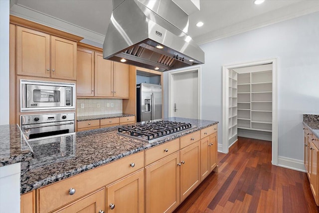 kitchen featuring appliances with stainless steel finishes, dark stone counters, island range hood, and dark wood-type flooring