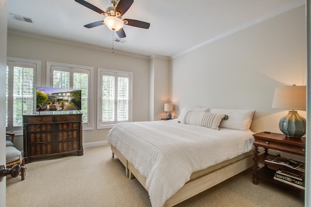 carpeted bedroom featuring ornamental molding, baseboards, and a ceiling fan