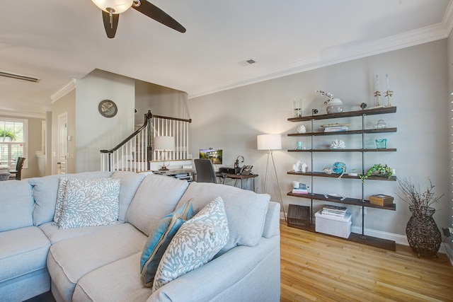 living room featuring light wood-style flooring, ornamental molding, ceiling fan, stairway, and an office area