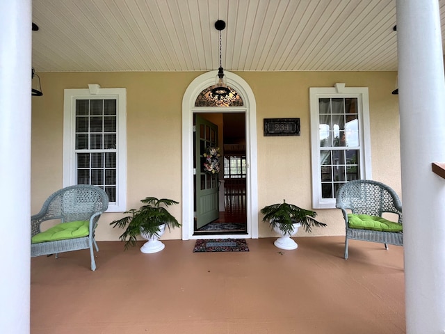 view of exterior entry with covered porch