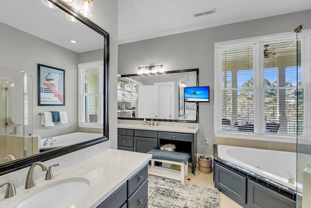 bathroom featuring visible vents, a shower stall, vanity, a tub with jets, and tile patterned floors