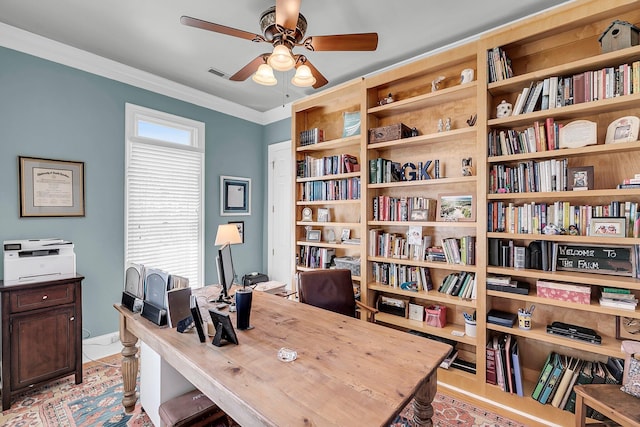 office featuring ceiling fan, visible vents, and ornamental molding