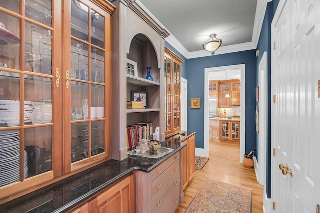 interior space featuring ornamental molding and light wood finished floors