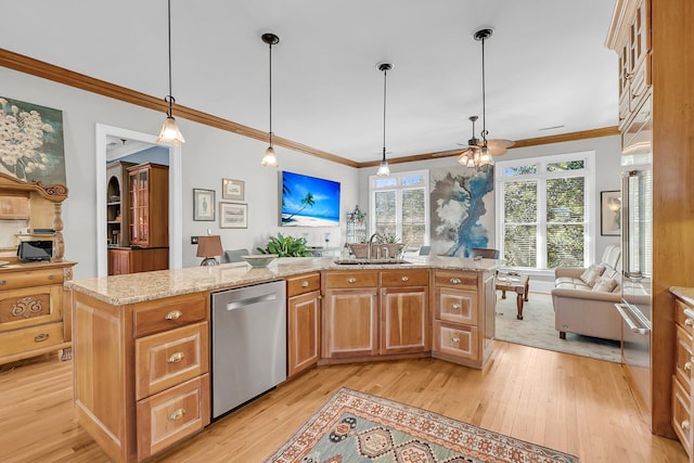 kitchen featuring open floor plan, a sink, light wood-style flooring, and stainless steel dishwasher