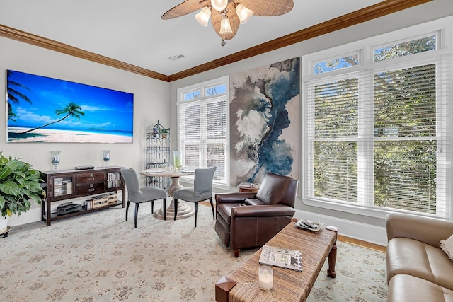 interior space featuring ornamental molding, visible vents, baseboards, and a ceiling fan