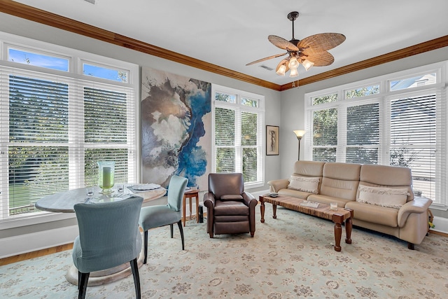 sunroom with visible vents, a ceiling fan, and a healthy amount of sunlight