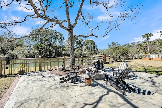 view of patio with a fire pit and fence