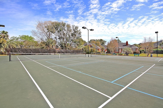 view of sport court featuring fence