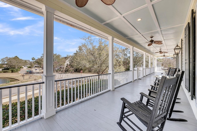 deck with a porch and ceiling fan