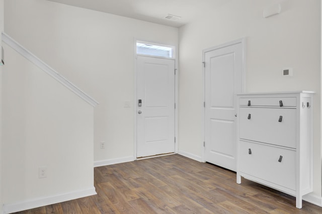 entrance foyer featuring baseboards and wood finished floors