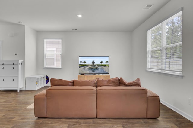 living room with plenty of natural light, recessed lighting, wood finished floors, and visible vents
