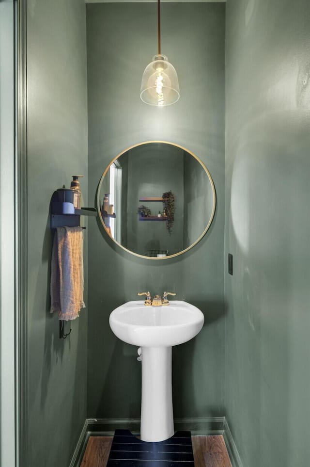 bathroom with baseboards and wood finished floors
