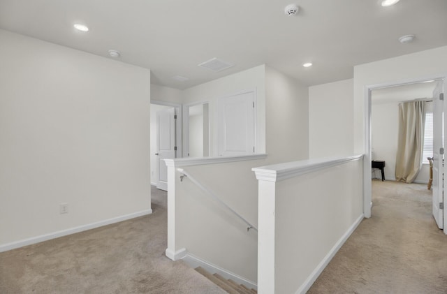 corridor with carpet floors, recessed lighting, baseboards, and an upstairs landing
