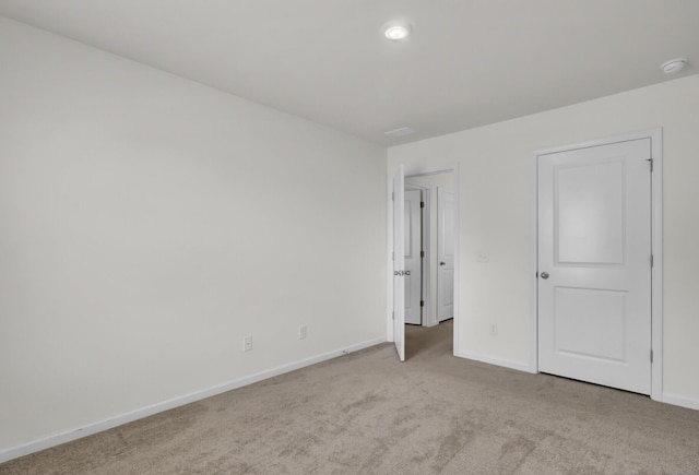 unfurnished bedroom featuring baseboards and carpet