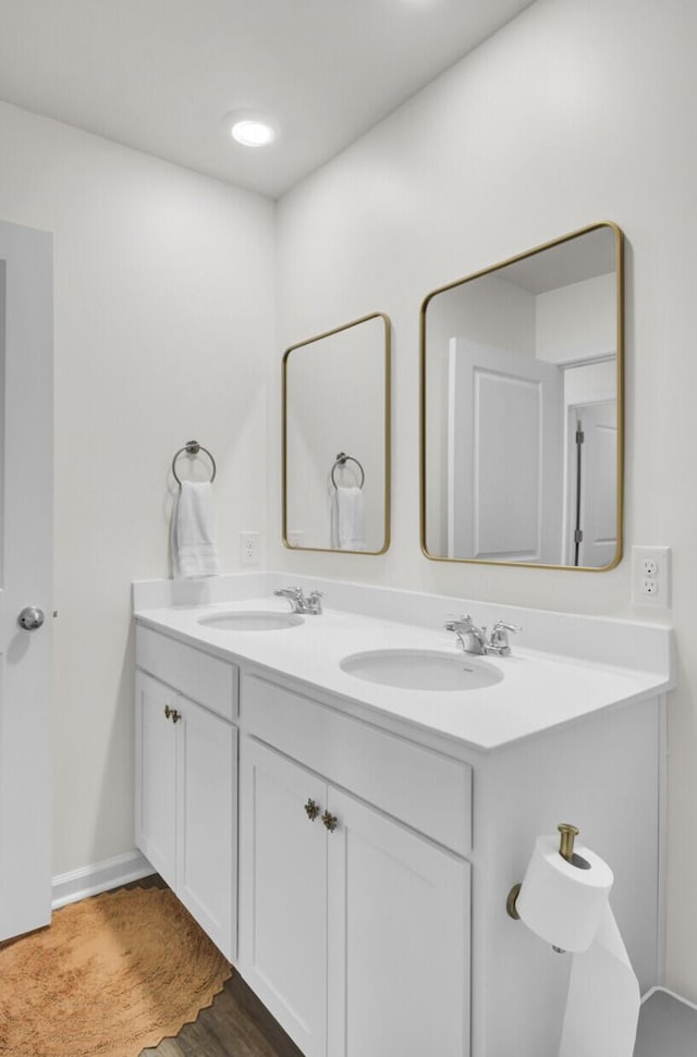 full bath featuring a sink and double vanity