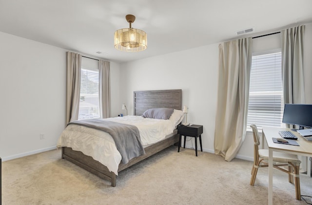 carpeted bedroom with visible vents and baseboards