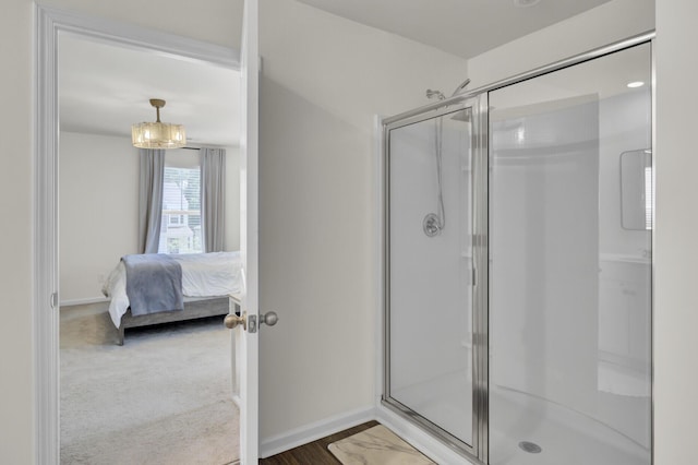 full bath featuring baseboards, ensuite bathroom, and a stall shower