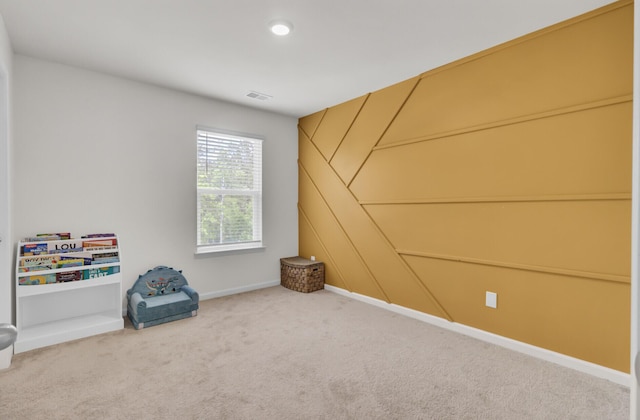 unfurnished room with visible vents, carpet, and baseboards