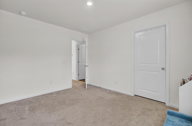 unfurnished bedroom featuring recessed lighting, baseboards, and light carpet