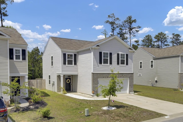 traditional-style home featuring concrete driveway, fence, a front lawn, and a garage