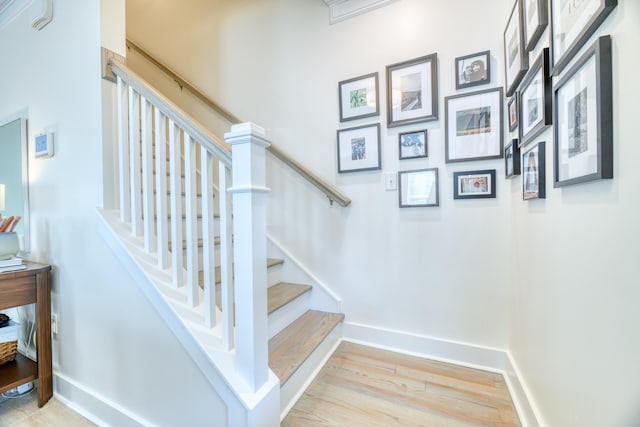 stairs with baseboards and wood finished floors