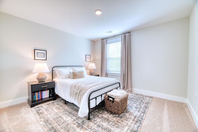 bedroom featuring baseboards, carpet flooring, and visible vents