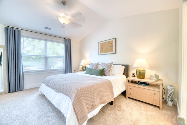 bedroom with lofted ceiling, light carpet, baseboards, and visible vents