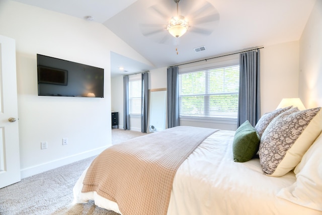 carpeted bedroom featuring ceiling fan, lofted ceiling, baseboards, and visible vents