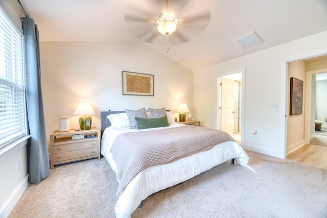 bedroom featuring lofted ceiling, baseboards, visible vents, and carpet floors