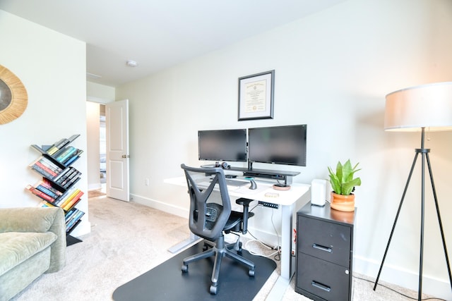 carpeted home office featuring baseboards