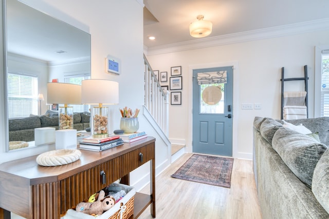 foyer featuring recessed lighting, baseboards, stairs, crown molding, and wood finished floors