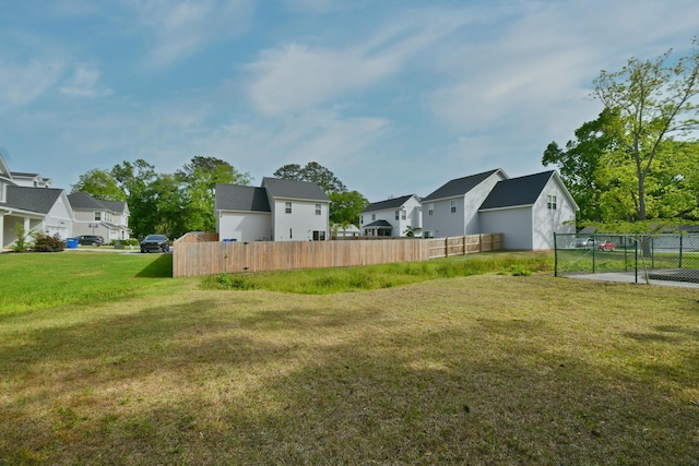 view of yard with fence and a residential view