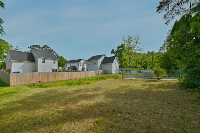 view of yard with a residential view and fence