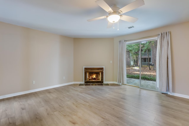7945 Parklane Ct Unit C, North Charleston, SC 29418 - unfurnished living room with wood finished floors, a warm lit fireplace, baseboards, and a ceiling fan