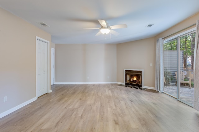 7945 Parklane Ct Unit C, North Charleston, SC 29418 - unfurnished living room with light wood finished floors, a ceiling fan, a fireplace with flush hearth, and baseboards