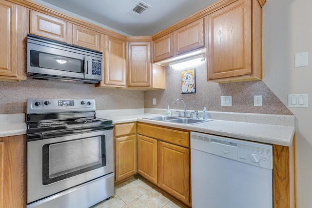 7945 Parklane Ct Unit C, North Charleston, SC 29418 - kitchen with stainless steel appliances, a sink, light countertops, light tile patterned floors, and backsplash