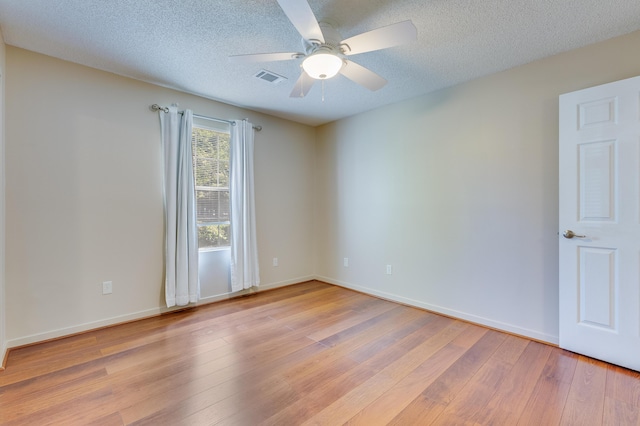 7945 Parklane Ct Unit C, North Charleston, SC 29418 - empty room with light wood-style flooring, a ceiling fan, baseboards, and a textured ceiling
