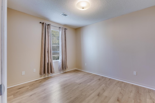 7945 Parklane Ct Unit C, North Charleston, SC 29418 - spare room with light wood-style floors, a textured ceiling, and baseboards
