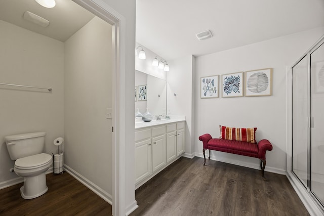 153 Wild Holly Dr, Moncks Corner, SC 29461 - bathroom featuring wood finished floors, toilet, a shower stall, vanity, and baseboards
