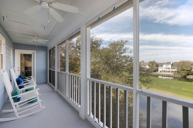 unfurnished sunroom featuring a ceiling fan