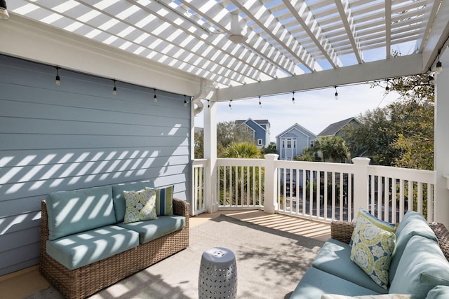 wooden deck with an outdoor hangout area and a pergola