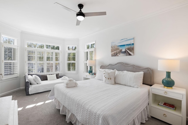 carpeted bedroom featuring crown molding, baseboards, and ceiling fan