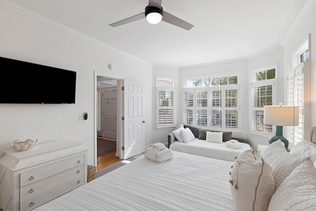 bedroom featuring ornamental molding, ceiling fan, and wood finished floors