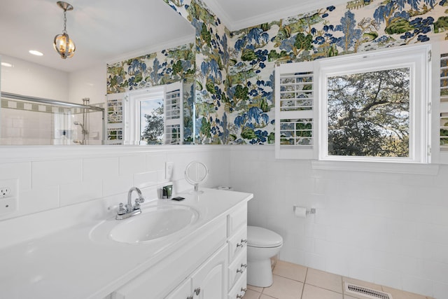 bathroom featuring toilet, wallpapered walls, visible vents, and a stall shower