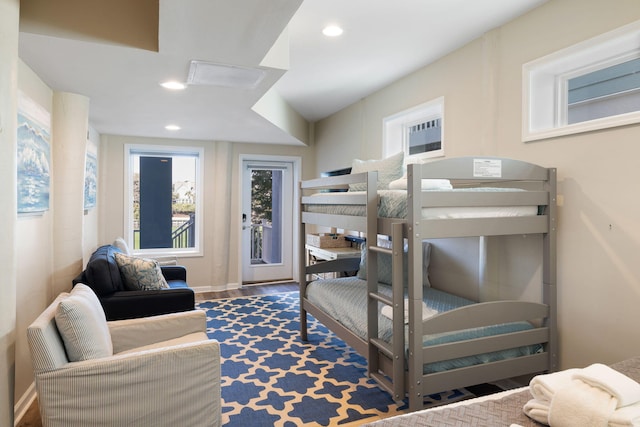 bedroom featuring access to outside, wood finished floors, and recessed lighting