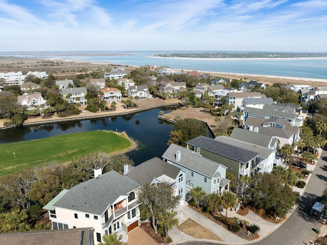 drone / aerial view with a residential view and a water view