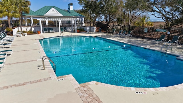 pool featuring fence, a pergola, and a patio